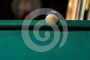 Billiards balls and cue on billiards table. Billiard sport concept.Ball in motion