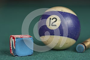 Billiards balls and cue on billiards table. Billiard sport concept. Chalk block on biliard table