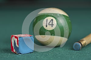 Billiards balls and cue on billiards table. Billiard sport concept. Chalk block on biliard table