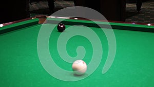 Billiards. Close-up of someone aiming the billiard ball with cue. Billiards game