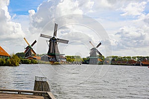 Billowing clouds in the background of historic dutch windmills in Netherlands once know as Holland.