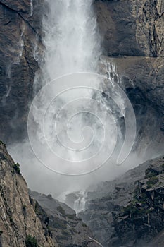 Billowing Mist Of Yosemite Falls Crashes Into The Surrounding Granite Cliffs