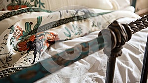 A billowy silk scarf printed with images of galloping horses and cacti dd over a wrought iron bed frame.