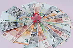 On the bills of different countries lies on top of the coronavirus. Dollar, euro, ruble bills. The concept of financial