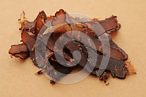 Biltong (dried meat) on a wooden board, this is a traditional food snack in South Africa