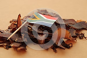 Biltong (dried meat) on a wooden board, this is a traditional food snack in South Africa