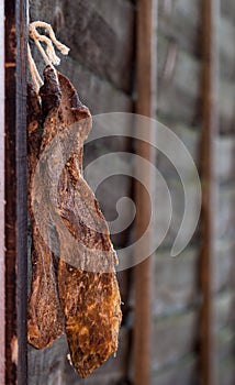 Biltong - dry cured meat on a wooden fence