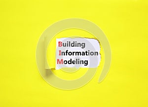 BIM building information modeling symbol. Concept words BIM building information modeling on white paper on beautiful yellow