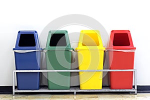 Bin, green, blue, yellow and red recycle bins with recycle waste symbol, Four colorful recycle bins garbage on wall white