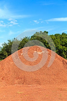 Bin of Red Clay Chips of Fine Coarseness