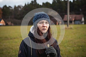 Binary portrait of an uncomprehending woman who can`t see her dog and stands helplessly in place. Authentic situation with dog. A