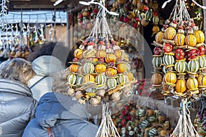 Binding dried citrus fruits at a New Year's street fair, natural flavorings.