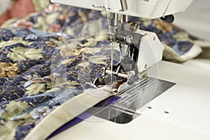 Binding quilt on machine.