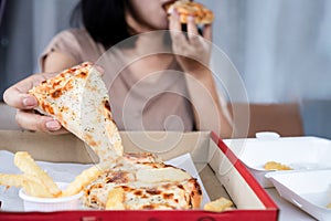 Binge eating disorder concept with woman over eating fast food pizza photo