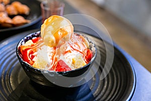 Bingsu, a Korean shaved ice dessert with sweet toppings such as vanilla ice cream, cheese cube and sweetened condensed milk.