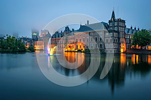 The Binnenhof palace in a foggy evening in Hague, Netherlands photo