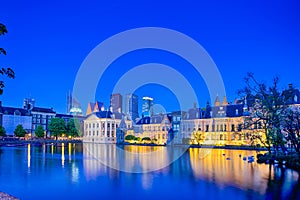 Binnenhof Palace of Parliament in The Hague in The Netherlands at Blue Hour.Skyscrapers Skyline On The Background