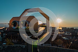 Binnoculars above the city of Lausanne to aid viewing the majestic cityscape at a romantic winter evening