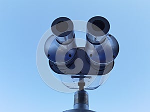 Binocular isolated on the blue sky watching on the sea