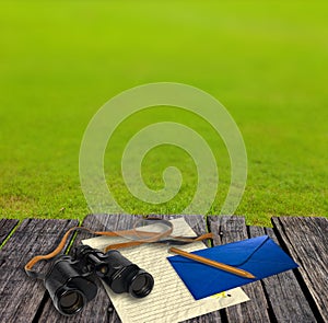 Binocular and letter on table, Adventure concept