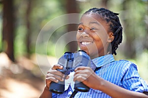 Binocular, search or happy boy child in forest hiking, sightseeing or discovery. Lens, equipment or excited African kid