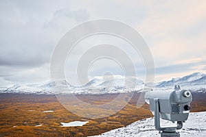 Binocular and view of the lapland gate landmark `lapporten` in Abisko national park, Sweden.