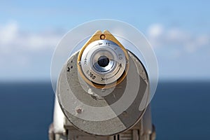 A binocular viewer looking out over blue sky.