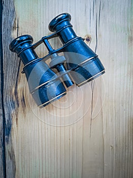 Binocular on wooden background vertical