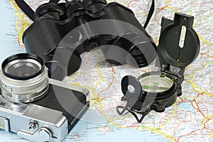 Binoculars, compass, camera and map