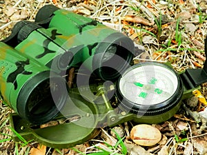 Binoculars and compass close up