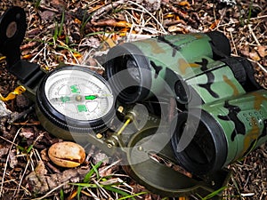 Binoculars and compass close up