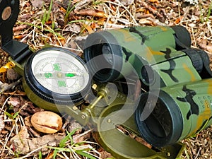Binoculars and compass close up