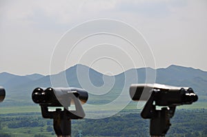 Binoculars with scenic view of North Korea on the 38th parallel line within the DMZ