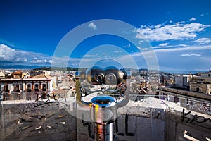 Binoculars to view the landscape of the ancient part of Cagliari, tiled crystals and bright blue sky, Sardinia, Italy