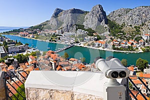Binoculars and town Omis in Croatia