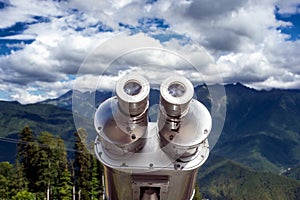 Binoculars on the viewport in the mountains. Look into the distance, beyond the horizon.