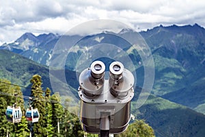 Binoculars on the viewport in the mountains. Look into the distance, beyond the horizon.