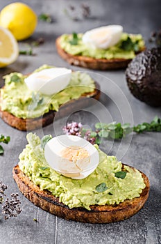 Bio avocado on bread with boiled egg