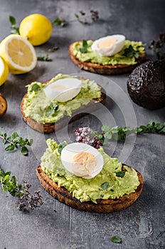 Bio avocado on bread with boiled egg