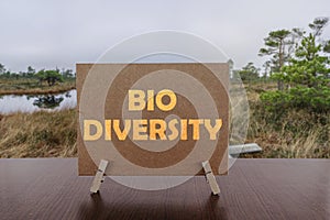 Bio diversity text on card on the table with swamp background