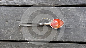 Bio food idea, spoon with a cherry and text