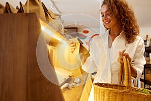 Bio Food Store. Smiling Woman Holding Basket And Choosing Goods At Grocery Store