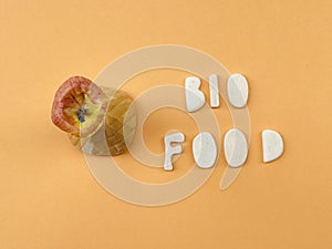 Bio Food text composed with wooden letters over orange color