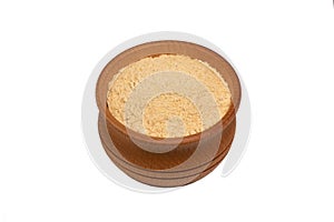 Bio organic dried ginger powder in wooden bowl
