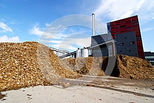 Bio power plant storage of wooden fuel against blue sky