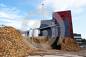 Bio power plant and storage of wooden fuel (biomass) against bl photo