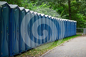 Bio public wc at a park. Locked, portable chemical lavatories. Nature background