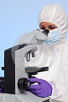 Biochemist looking through a microscope photo