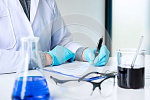 Biochemistry laboratory research, Chemist is analyzing sample an