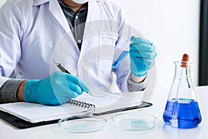 Biochemistry laboratory research, Chemist is analyzing sample in